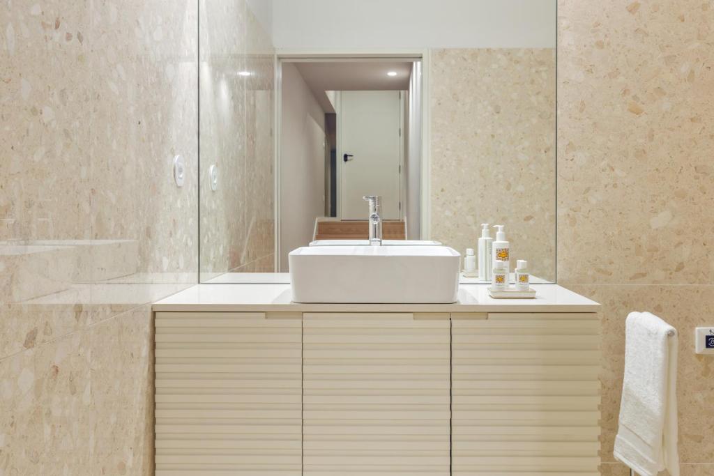 a bathroom with a sink and a mirror at 108MM House in Porto