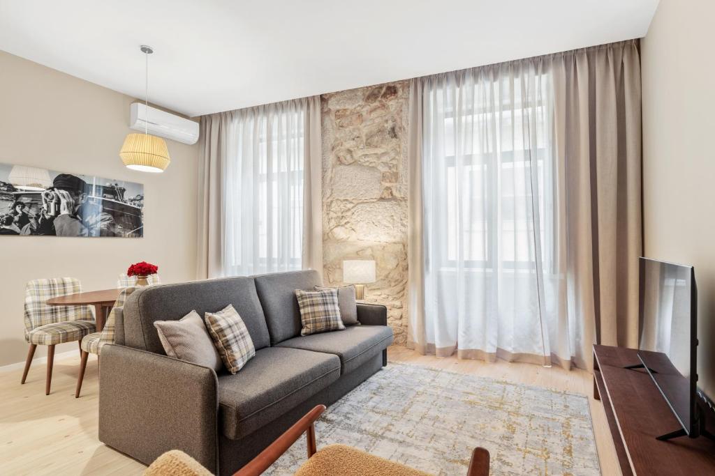 a living room with a couch and a table at 108MM House in Porto