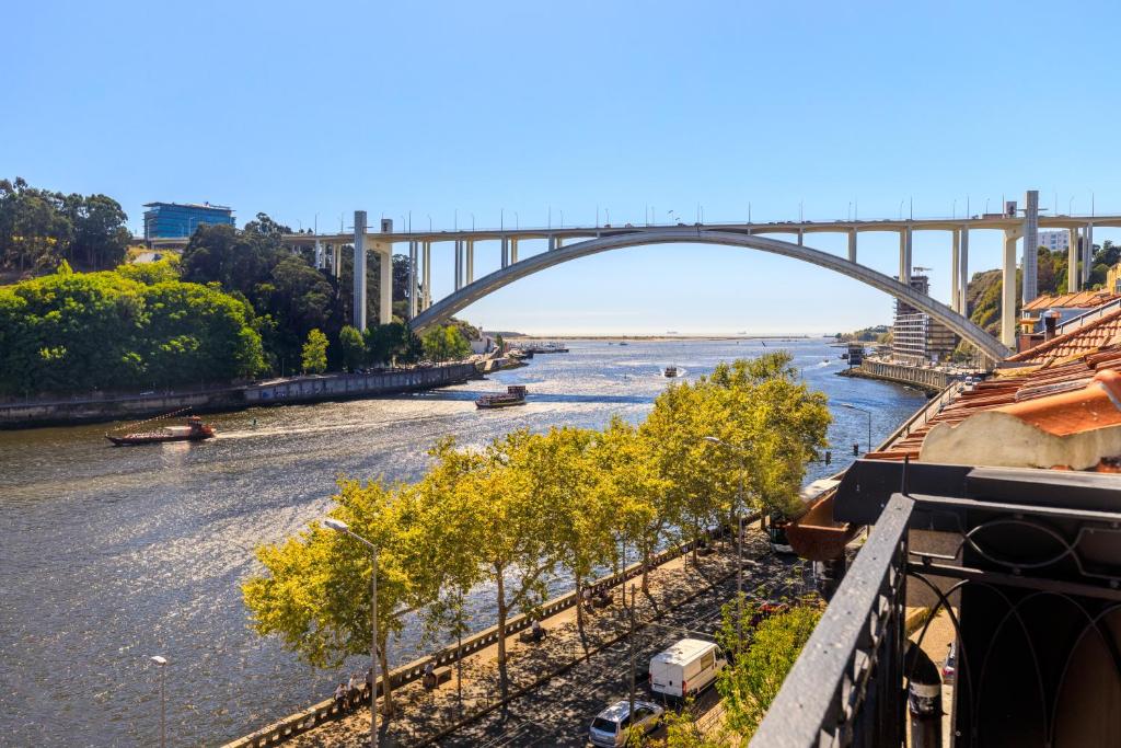 a view of a river with a bridge in the background at 108MM House in Porto