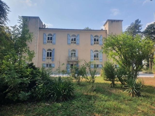 a large building with trees in front of it at Domaine de ferrabouc in Mas-Saintes-Puelles