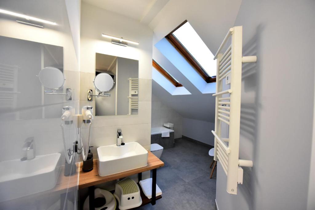 a bathroom with a sink and a mirror at Pensjonat Zuzanna in Hajnówka