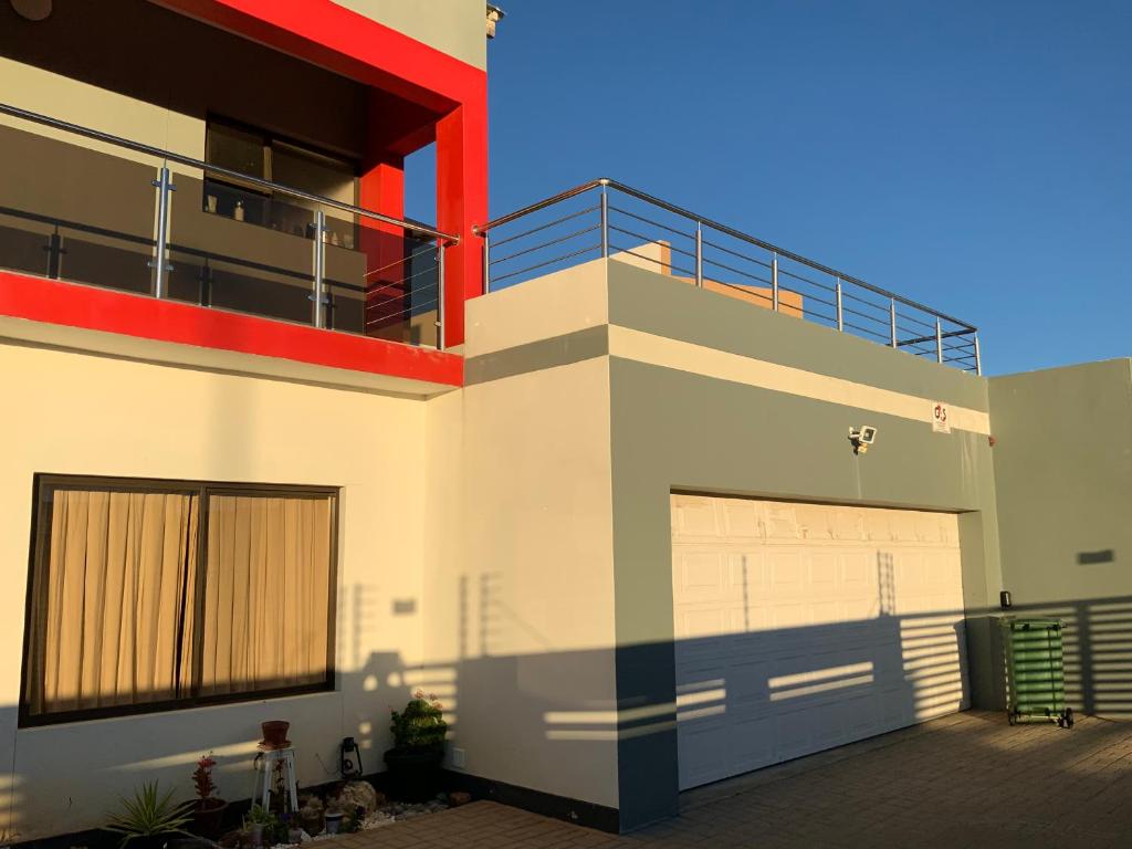 a large house with a garage and a balcony at Almina villa in Windhoek