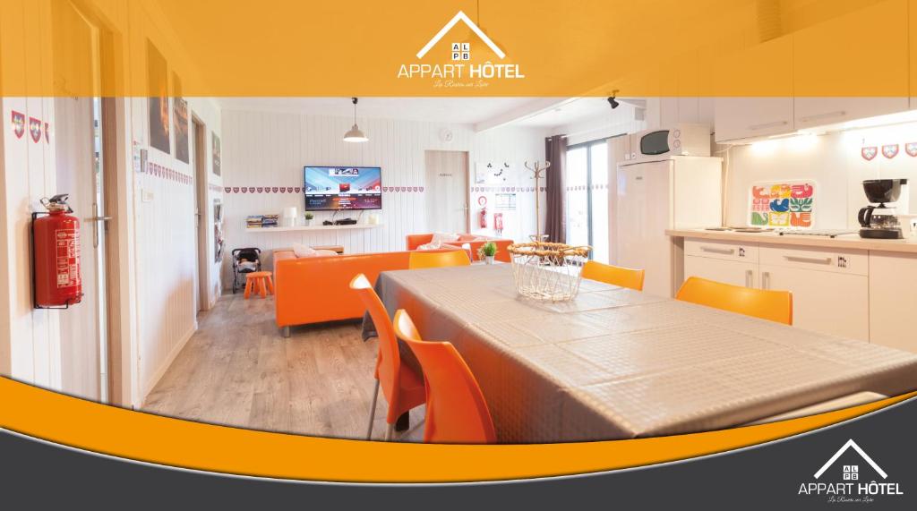una cucina e una sala da pranzo con tavolo e sedie di Appart'hôtel Les Prés Blondeau de 1 à 10 personnes a Les Rosiers