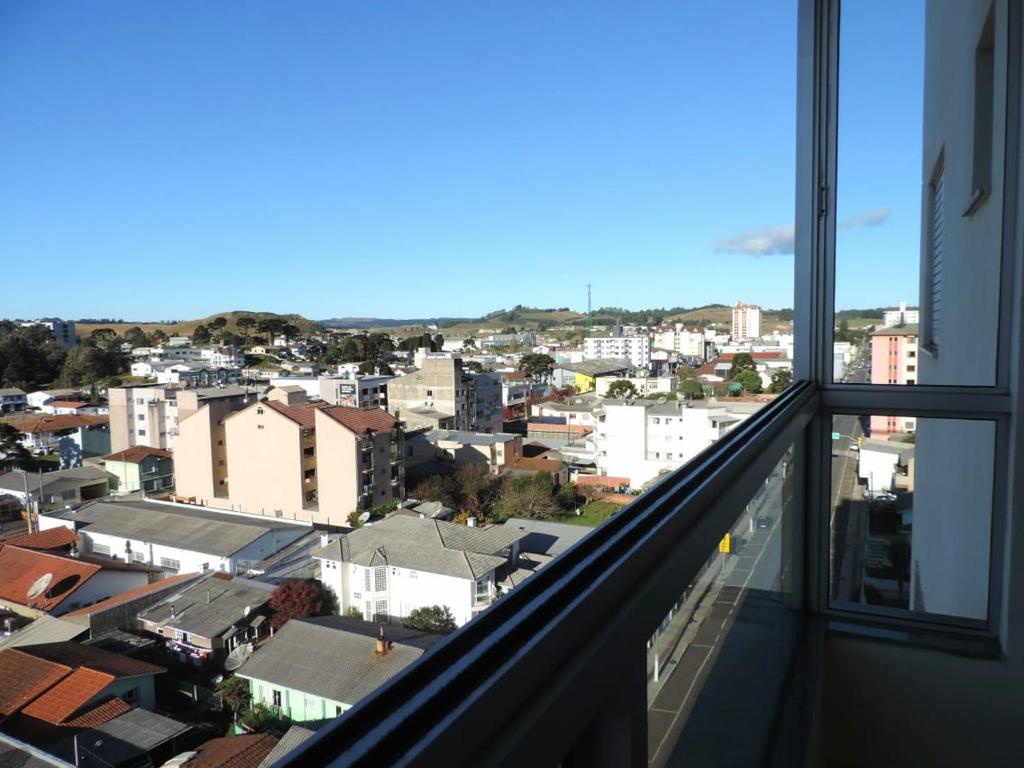 a view of a city from a balcony at Apê aconchegante e quentinho em São Joaquim in São Joaquim