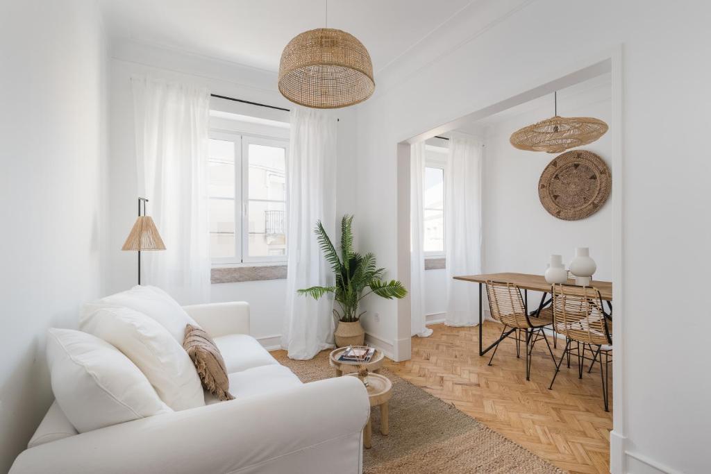 a white living room with a white couch and a table at Casa Boma Lisboa - Charming and Spacious Apartment - Campolide II in Lisbon