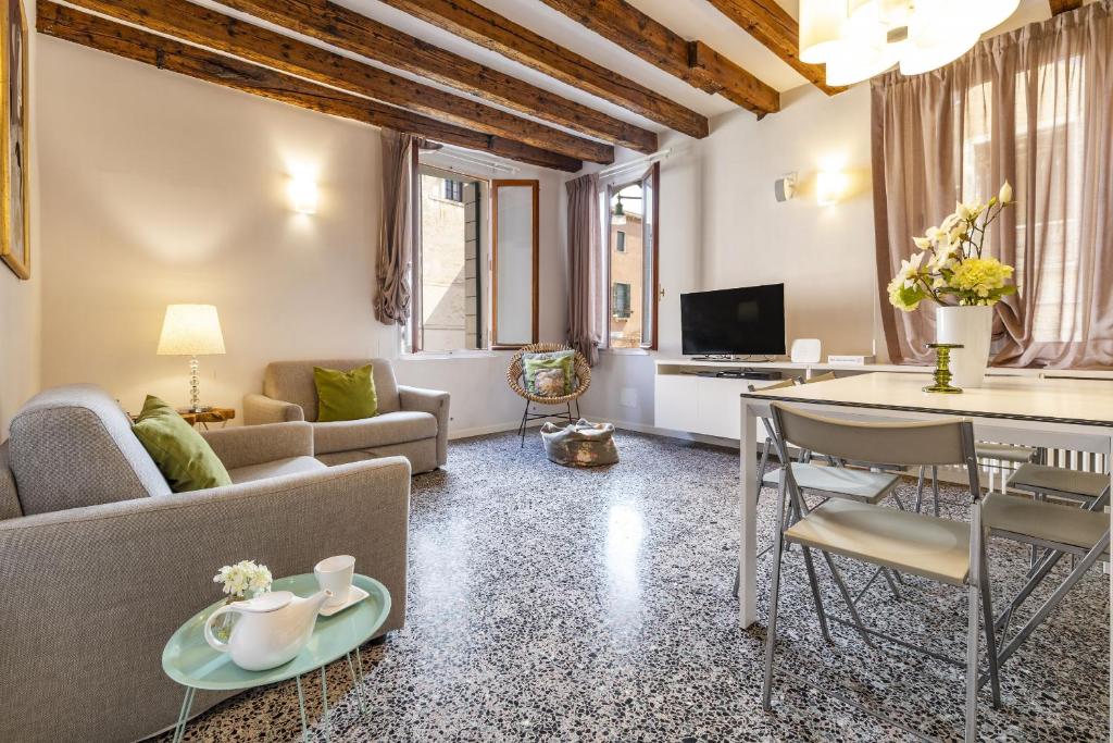 a living room with a couch and a table at CA FOSCA HOME - Campo Santa Fosca in Venice