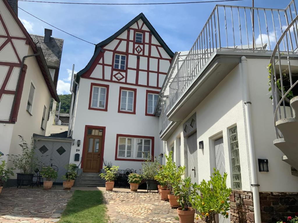a house with a red and white building at Ferienhaus Mosel 2.0 in Bremm