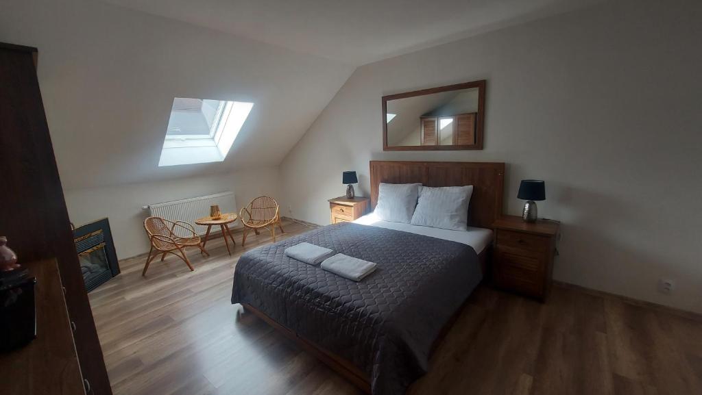 a bedroom with a bed and a mirror and a table at Chata Zdeňka Abertamy in Abertamy