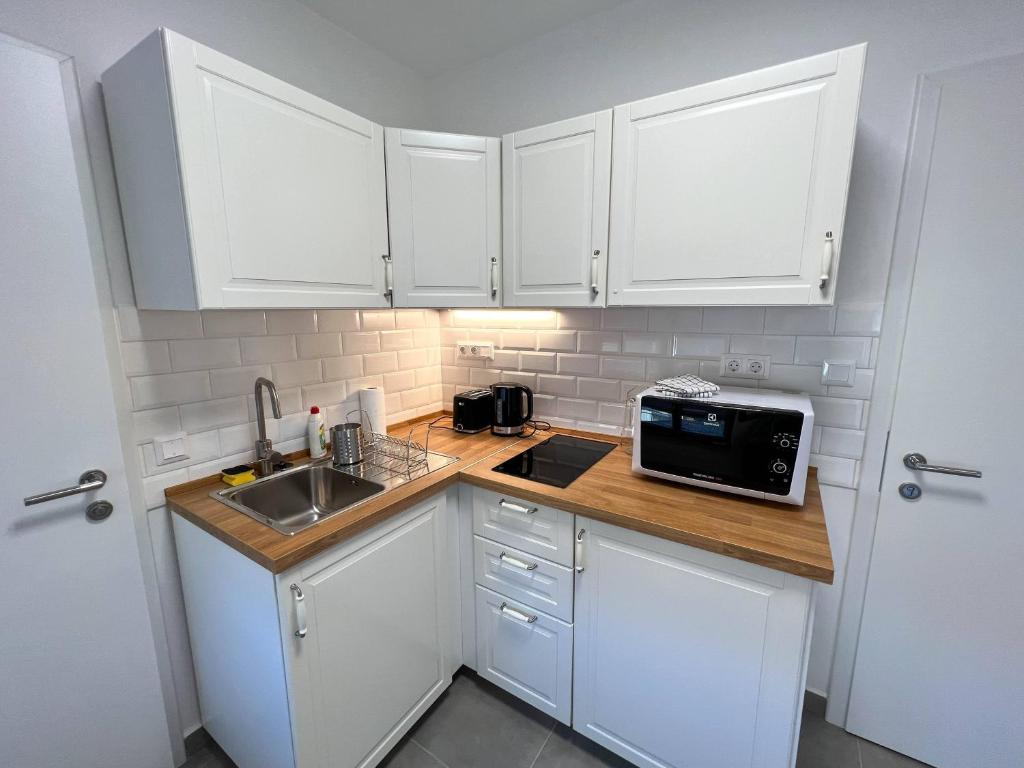 Kuchyň nebo kuchyňský kout v ubytování Lujza Apartman
