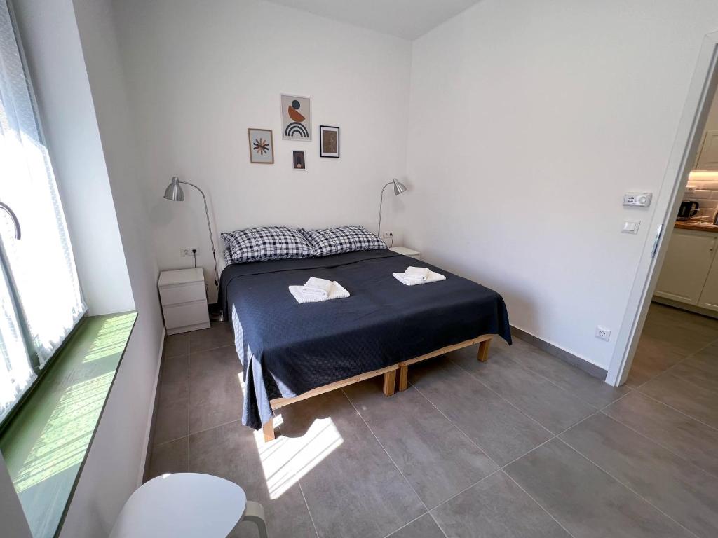 Postel nebo postele na pokoji v ubytování Lujza Apartman