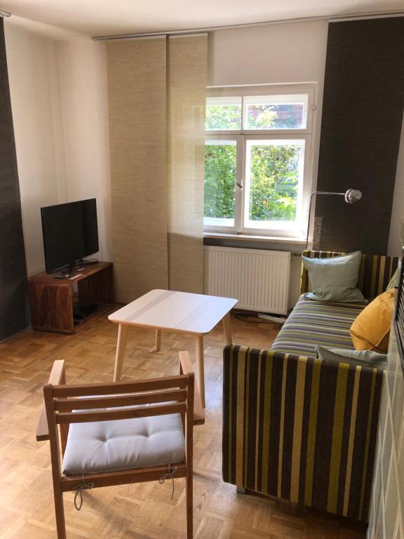 a living room with a couch and a table at Wohnung mit Charme in Munich