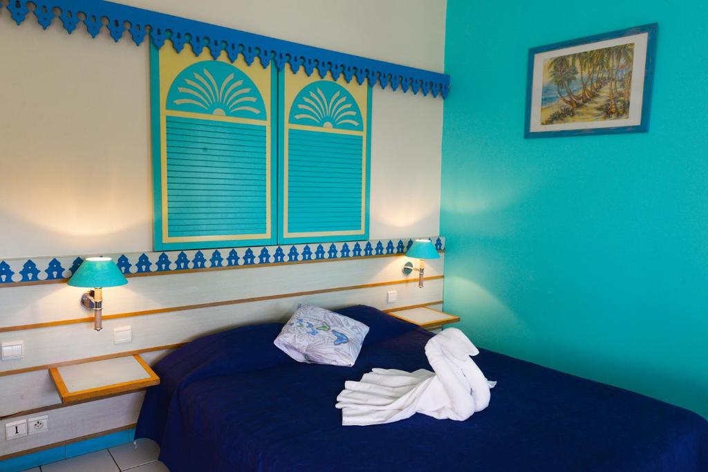 Postel nebo postele na pokoji v ubytování Charmant studio au Carayou avec piscine et spa