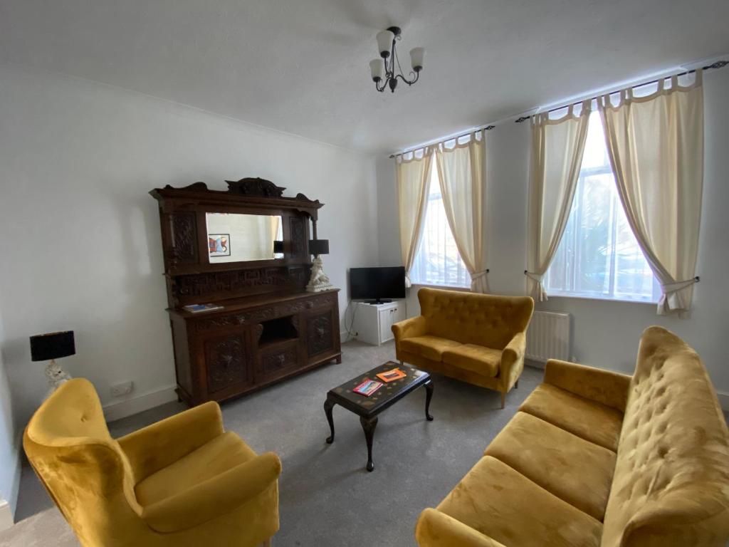 a living room with a couch and chairs and a table at Number 29, Westgate-on-Sea in Westgate-on-Sea