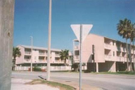 a building with a street sign in front of it at Knights Inn Corpus Christi in Corpus Christi