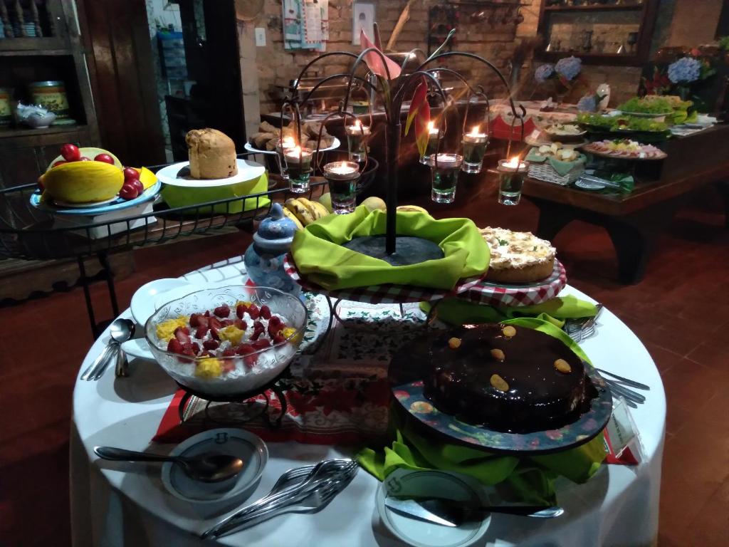 a table with many different types of food on it at Vista Linda Hotel in Itatiaia