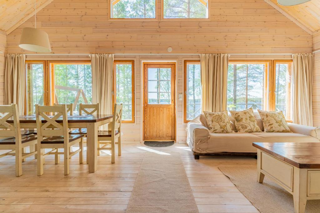 a living room with a couch and a table at Patalaiska Cottages in Ruokolahti