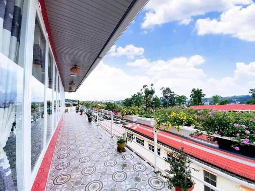 a balcony of a building with potted plants on it at Mr.Khanh Coffee in Xuân Trường