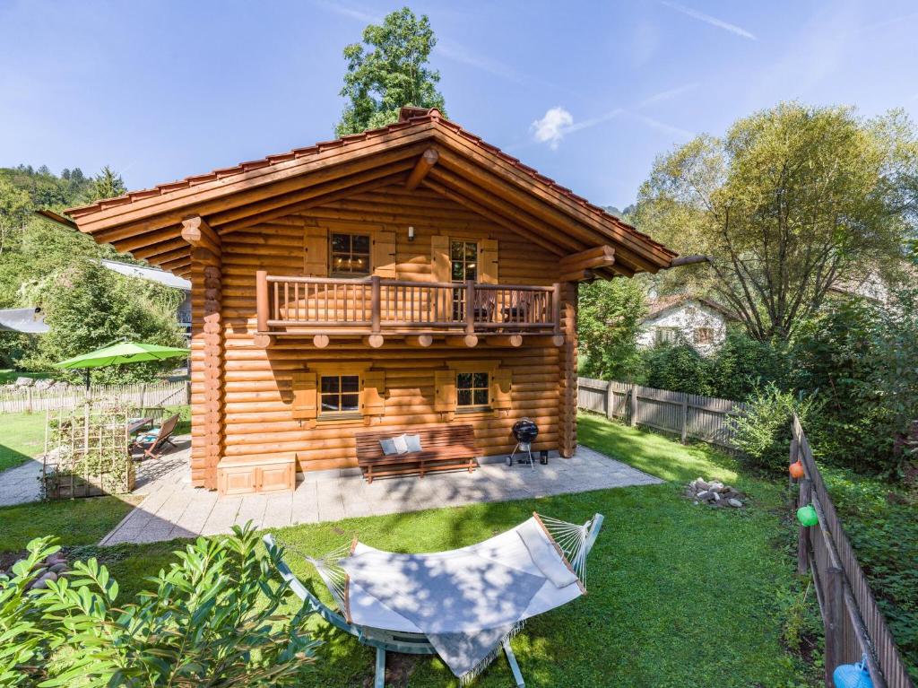 a log cabin with a balcony and a deck at Audorfer Blockhaus in Oberaudorf