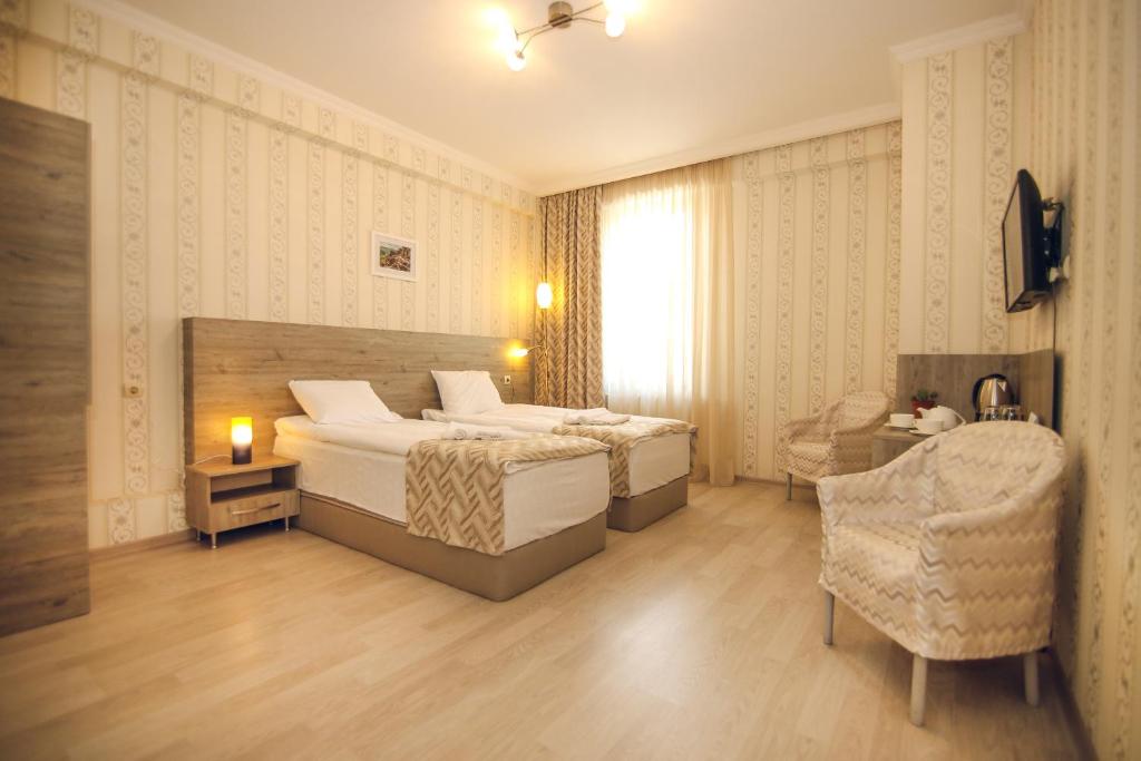 Postel nebo postele na pokoji v ubytování Hotel Kera