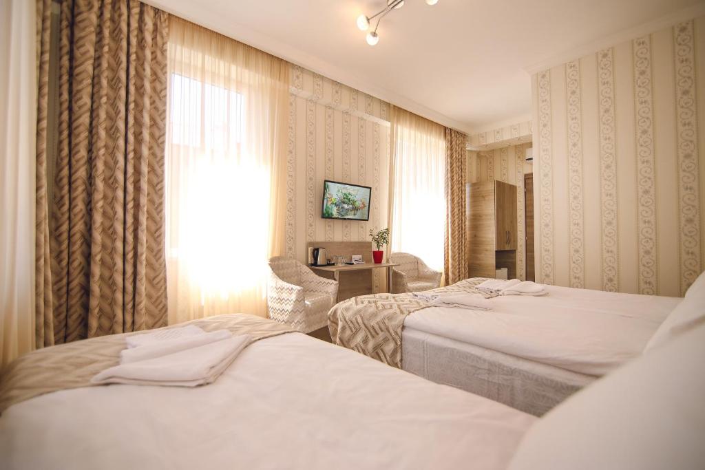 Postel nebo postele na pokoji v ubytování Hotel Kera