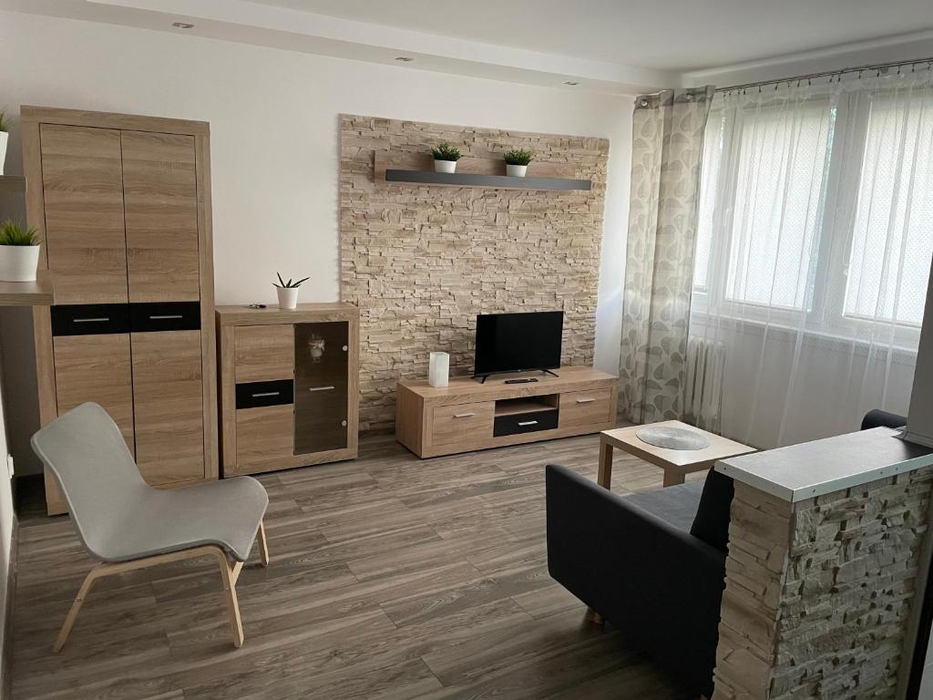 a living room with a couch and a television at Apartament Północ in Koszalin