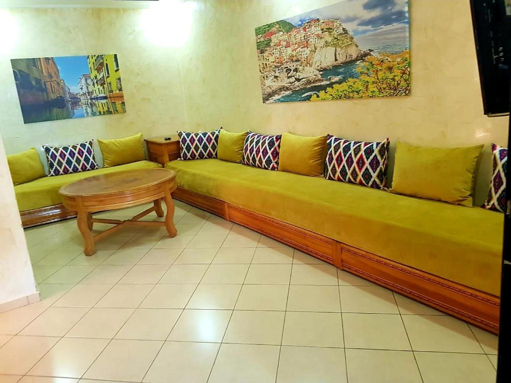 a living room with a couch and a table at Dar Sara in Asilah