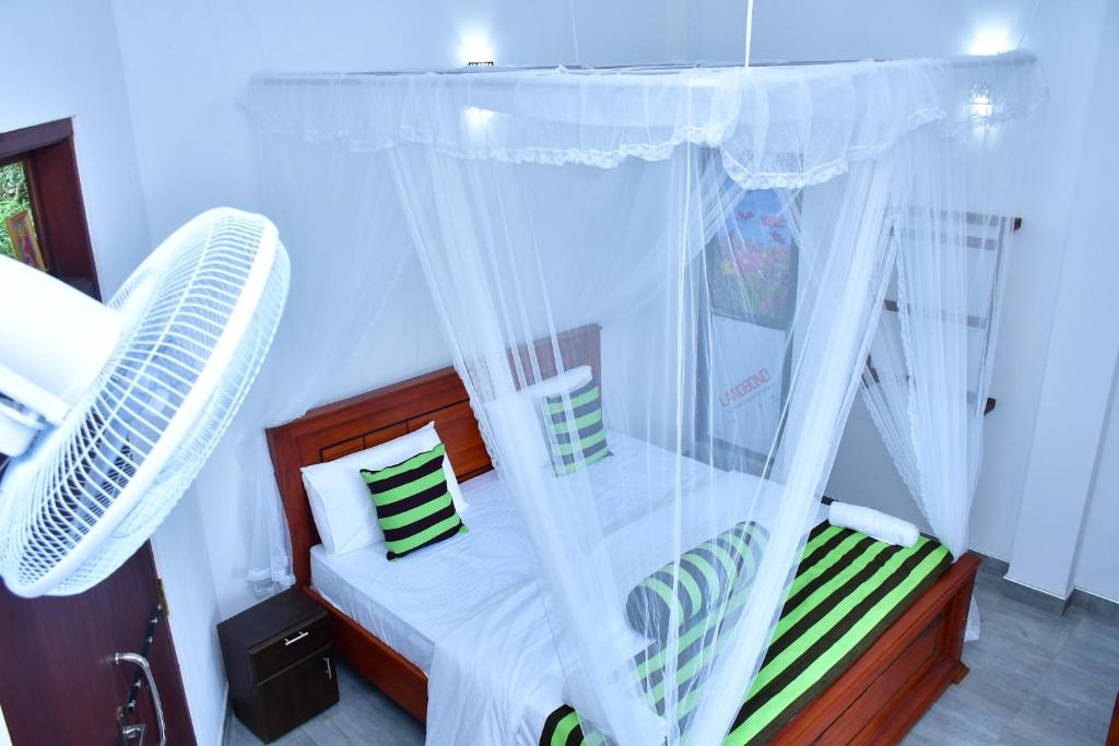 Postel nebo postele na pokoji v ubytování Dilshan Cottage