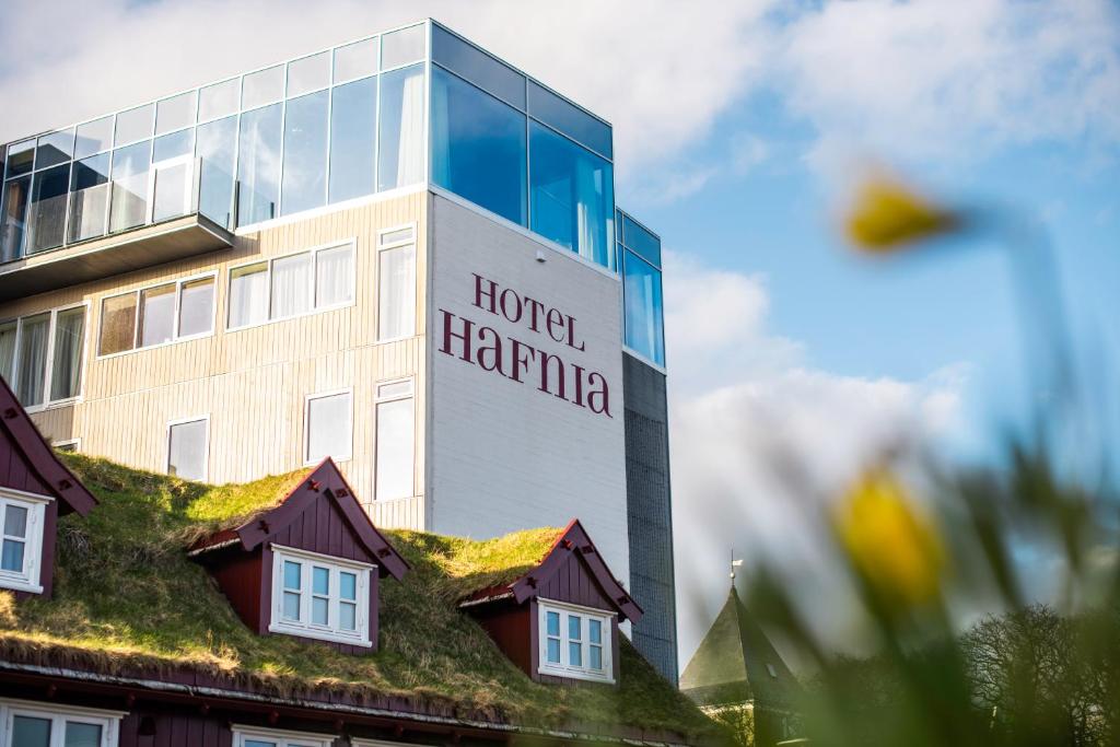 a hospital building with a building with a grass roof at Hotel Hafnia in T&oacute;rshavn
