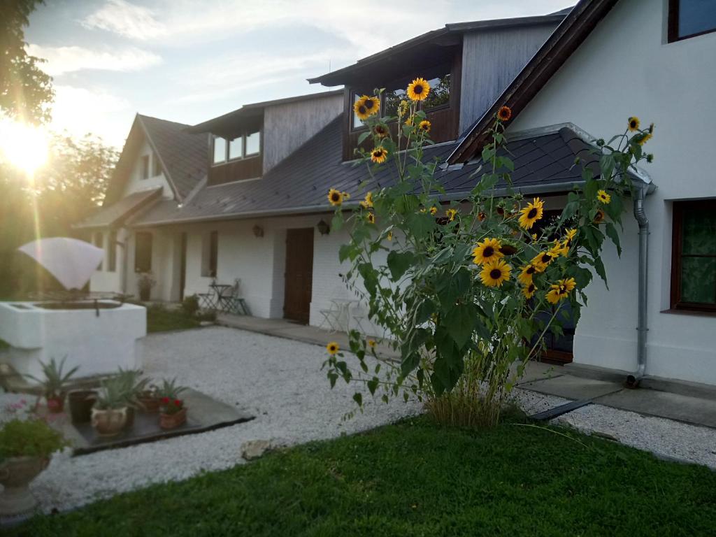 a house with sunflowers on the side of it at Kutny Residence -Chateau Schaal in Hegyhátsál