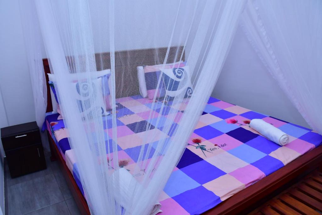 Postel nebo postele na pokoji v ubytování Dilshan Cottage