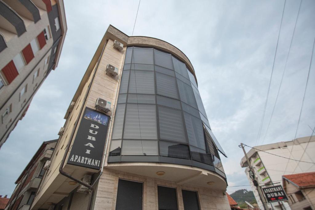 a building with a large window on the side of it at Apartmani Rekic-Dubai in Novi Pazar