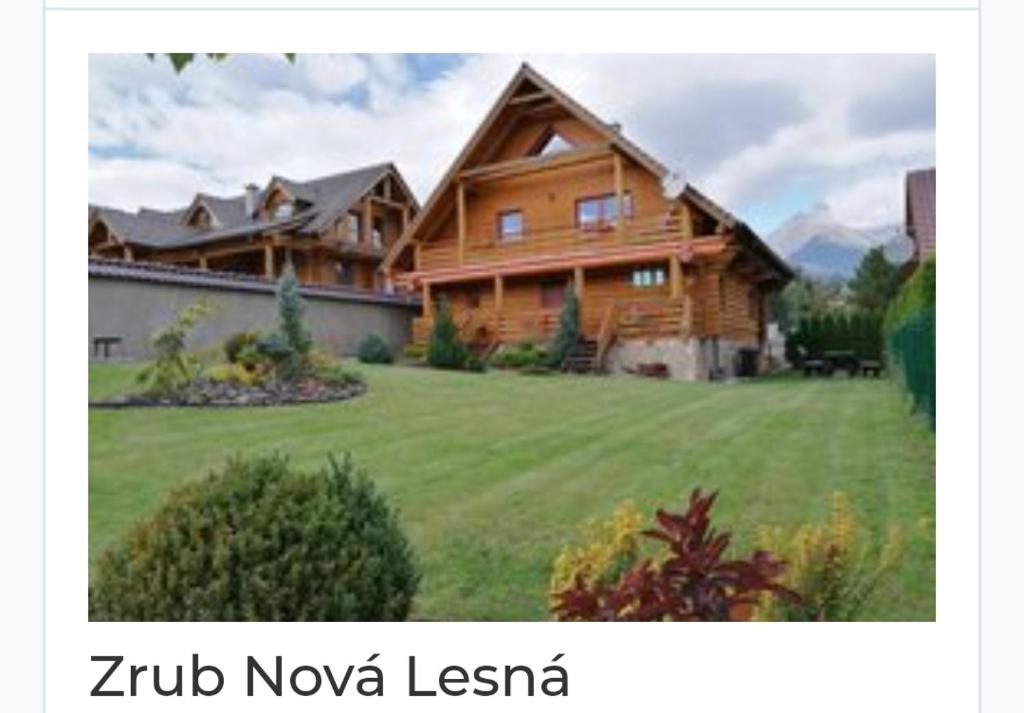 a large wooden house on a green lawn at Zrub Nová Lesná in Nová Lesná