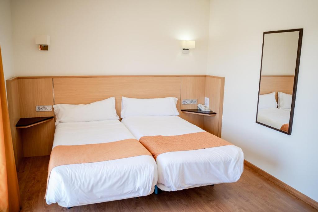 Postel nebo postele na pokoji v ubytování Hotel Malena