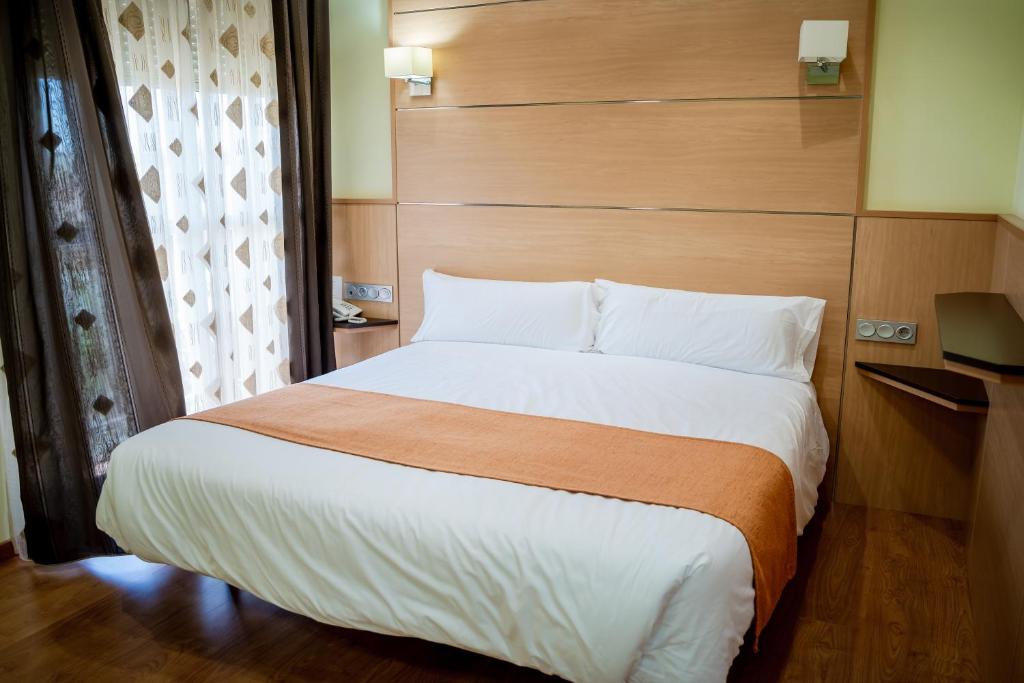 Postel nebo postele na pokoji v ubytování Hotel Malena