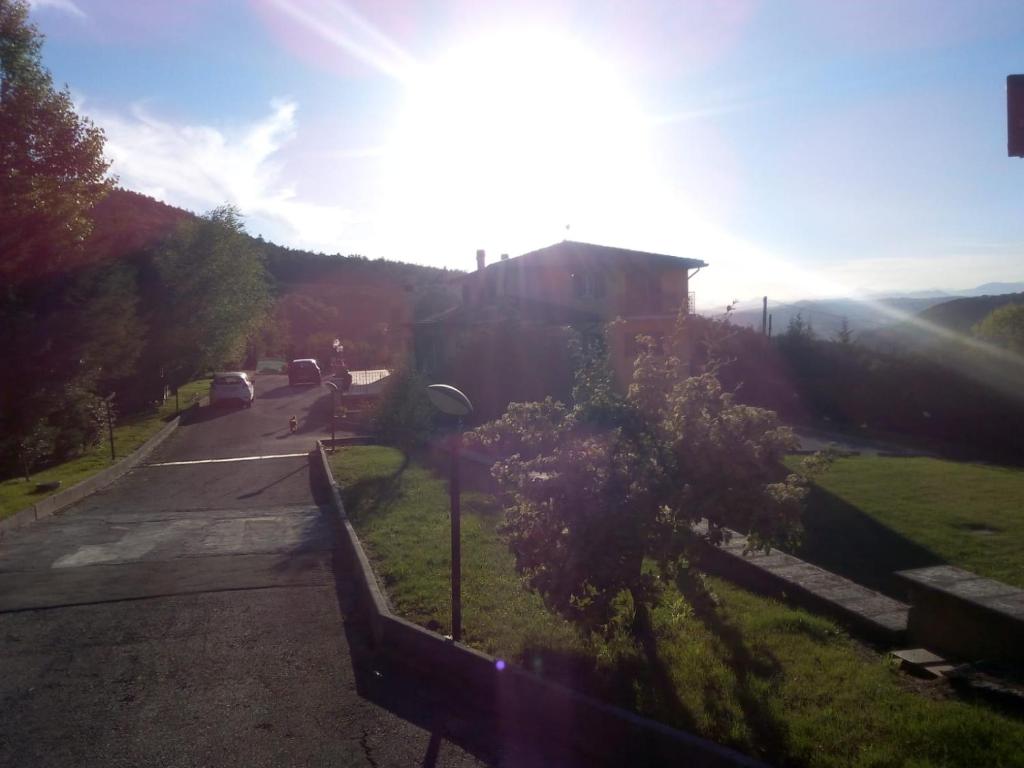 a view of a street with a building and a tree at La casa di mezzo-affitti brevi-zona ospedali in Busso