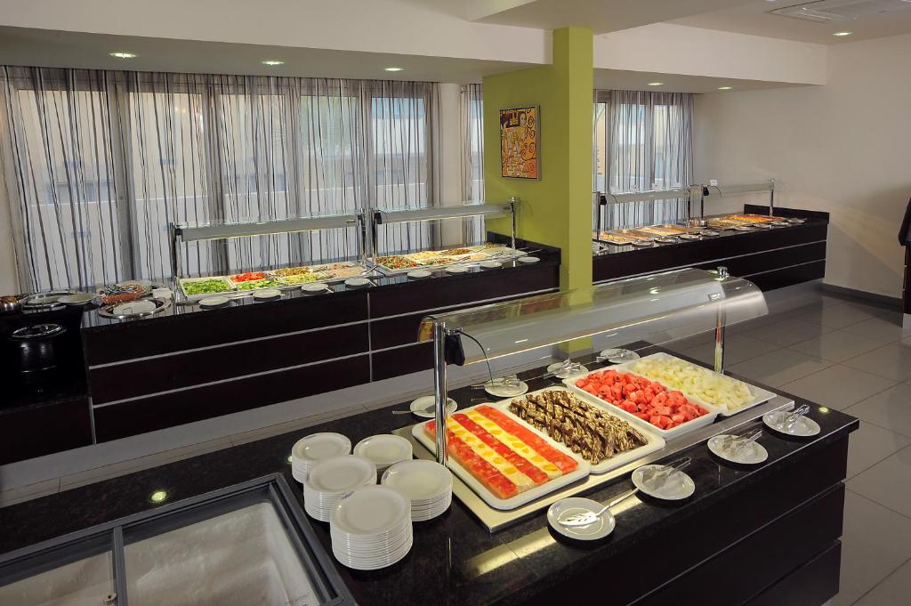 a buffet line with many different types of food at Euronapa Hotel Apartments in Ayia Napa