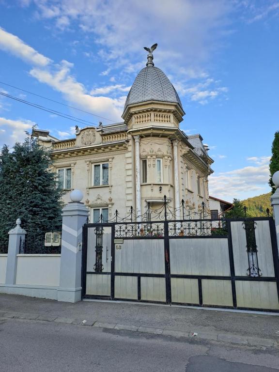 a building with a gate in front of it at Casa Irimescu in Gura Humorului