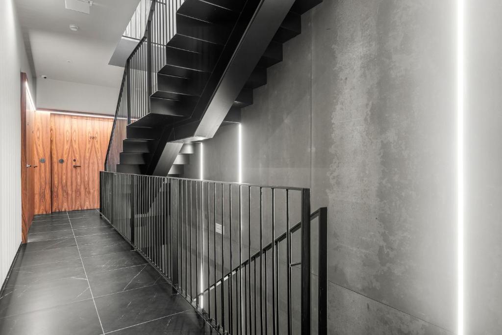 a staircase in a building with a black railing at 108MM House in Porto