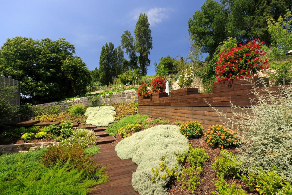 a garden with many plants and flowers on a hill at 108MM House in Porto