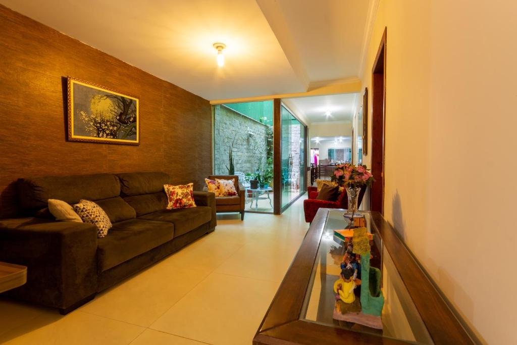 a living room with a couch and a table at Pousada Jardim Brasília in Brasília