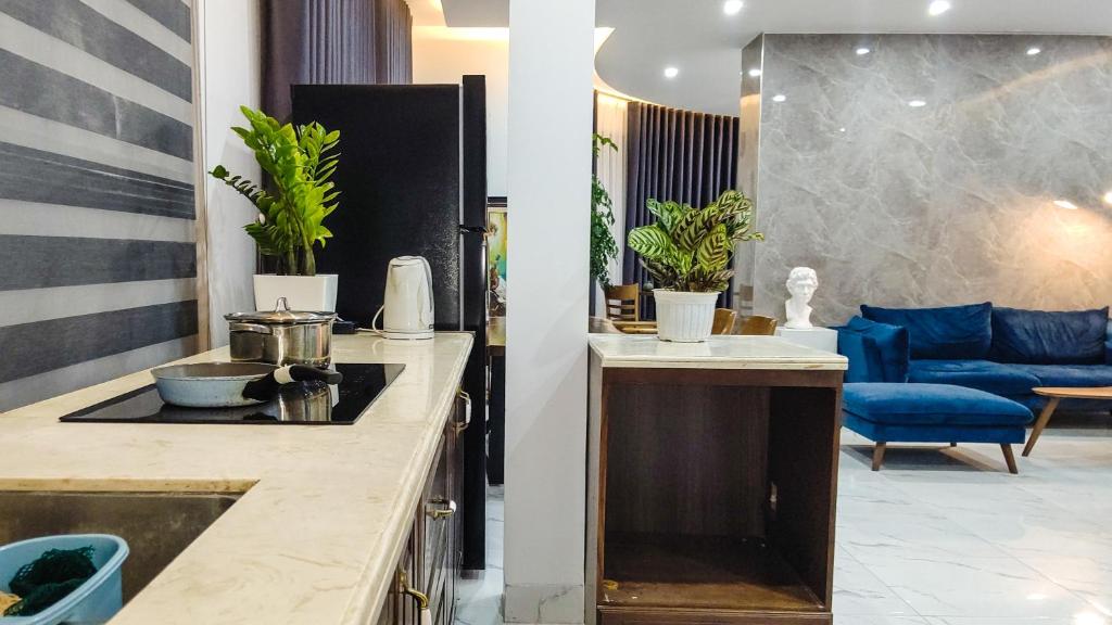 a kitchen with a sink and a living room at Green Line Long Bien - Serviced Apartment - Ngoc Thuy - Hanoi in Hanoi