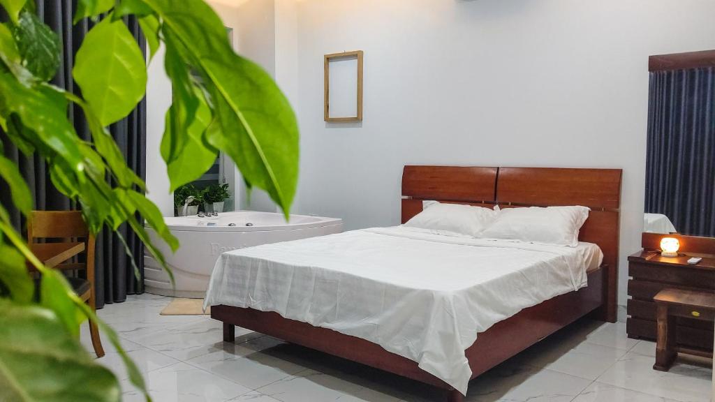a bedroom with a bed and a bath tub at Green Line Long Bien - Serviced Apartment - Ngoc Thuy - Hanoi in Hanoi