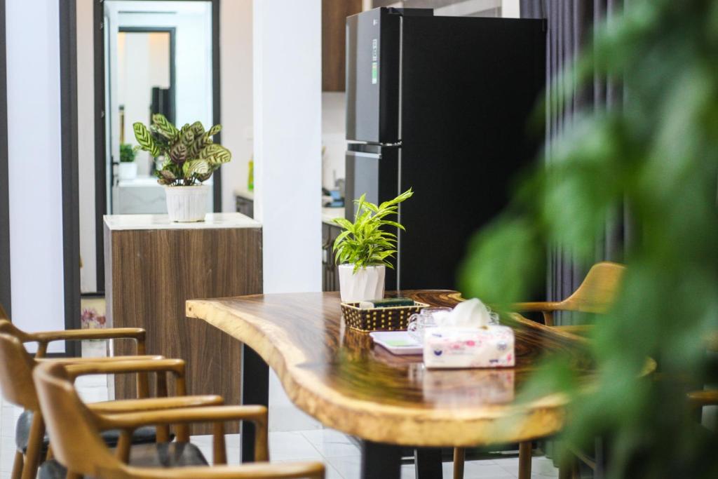 a kitchen with a table with chairs and a refrigerator at Green Line Long Bien - Serviced Apartment - Ngoc Thuy - Hanoi in Hanoi
