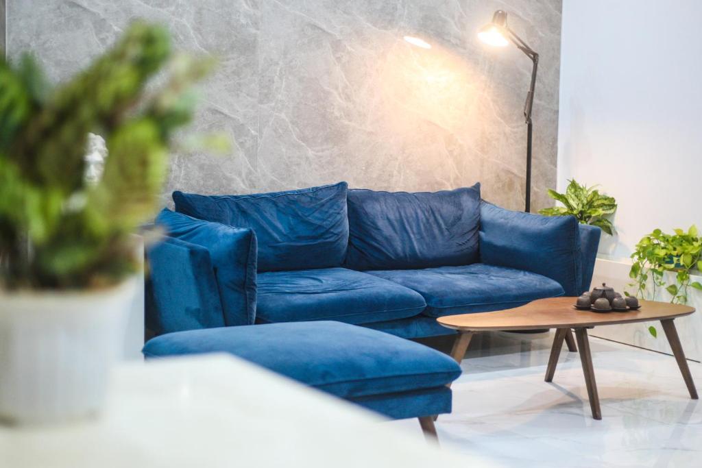 a blue couch and a coffee table in a living room at Green Line Long Bien - Serviced Apartment - Ngoc Thuy - Hanoi in Hanoi