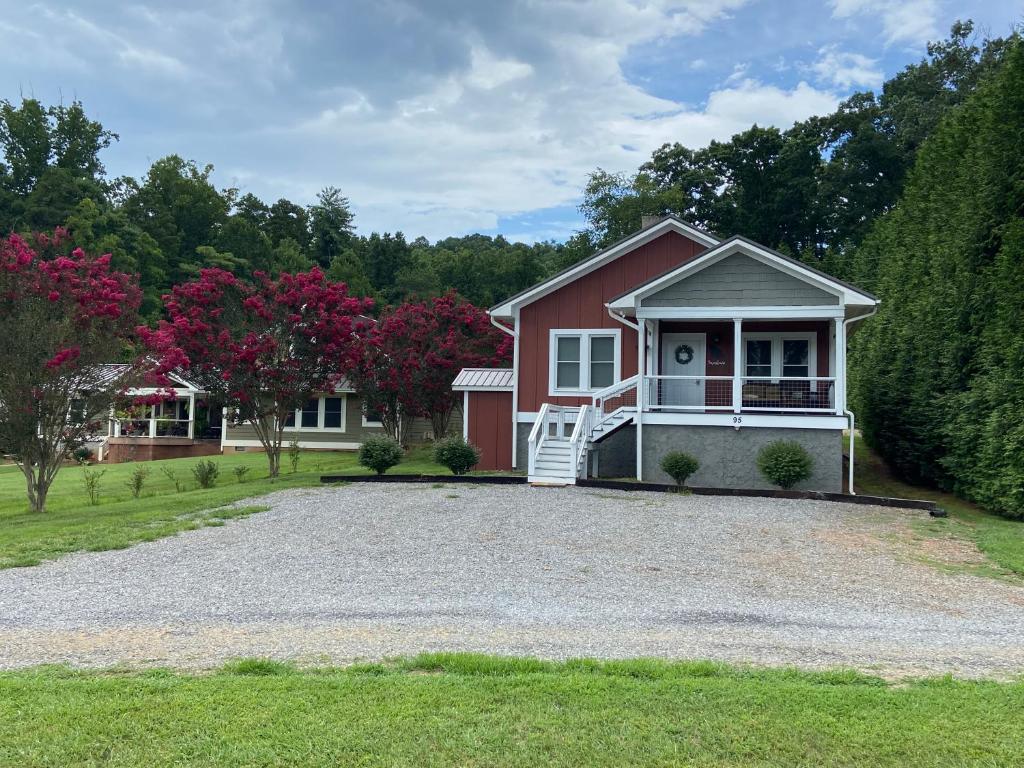 a red house with a gravel driveway at The Farmhouse at Wolfehaven in Asheville