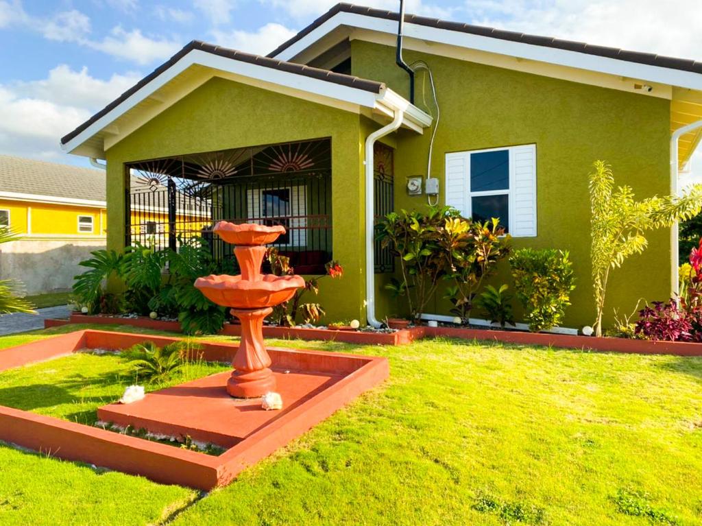 a red fountain in the yard of a house at PARADISe VILLA 2 in Mammee Bay
