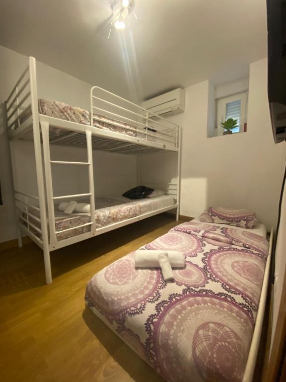 a bedroom with two bunk beds in a room at Karl&Deby Madrid in Madrid