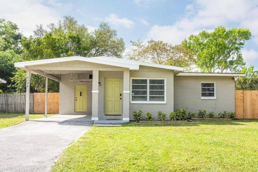 a small house with yellow doors in a yard at Private Oasis at Palm Casita in St Petersburg