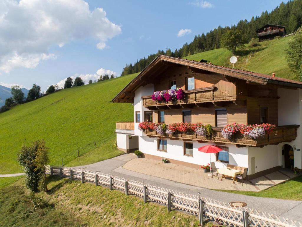 a house on a hill with flowers on the balcony at Haus Sporer in Gerlosberg