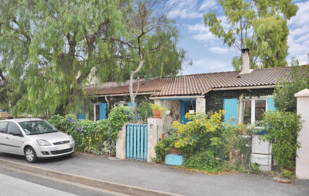 a car parked in front of a blue house at Awesome Home In La Crau With 3 Bedrooms And Wifi in La Crau